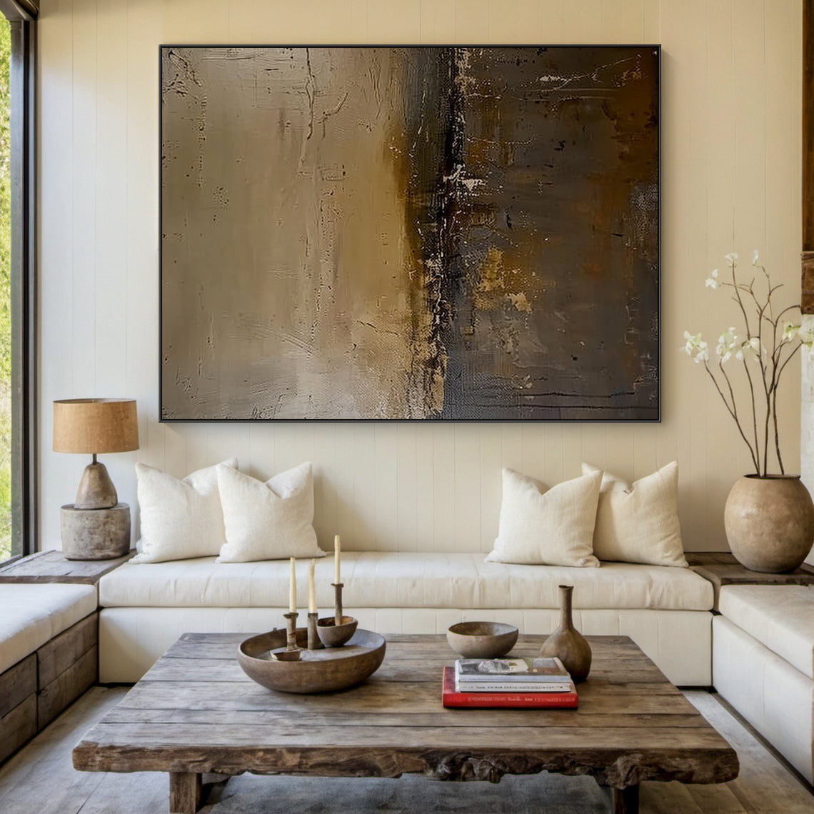 General Abstract Black Art Plaster-like Textured Japandi Wall Decor with Scratched Layers (AURA197) — Earth tone base (beige, light brown, dark brown) with black accents, rough layered texture from scratch and smudge strokes, modern abstract style ideal for minimalist, modern or luxury home spaces like entryways or living rooms. Mounted above a sleek marble coffee table in a bright contemporary living room with neutral-toned furniture and soft natural light filtering through sheer curtains.
