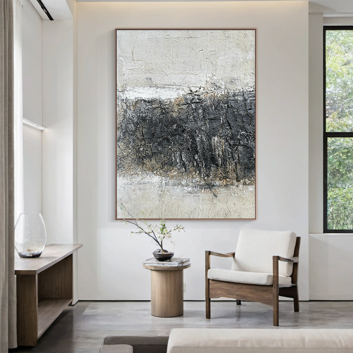 Abstract Black White Crackle Texture Art (AURA219) | Modern Abstract Minimalist Luxe Wall Decor. Thick knife strokes, tactile plaster finish, 3D impasto, subtle light gold/beige undertones. Displayed above a light wood sofa in a serene Japandi living room, serving as a striking focal point. Balances deep black, soft off-white & gray with intentional crackle texture (wabi-sabi influences). Framed abstract piece with strong light-dark contrast and layered, tactile surface—ideal for modern bedrooms, home offic