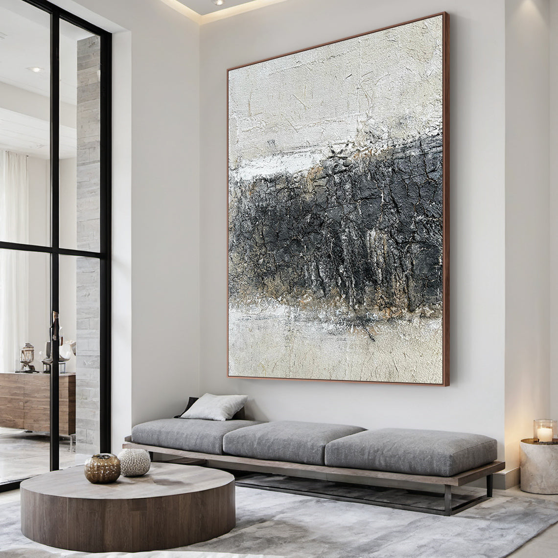 Abstract Black White Crackle Texture Art (AURA219) | Modern Abstract Minimalist Luxe Wall Decor. Thick knife strokes, tactile plaster finish, 3D impasto, subtle light gold/beige undertones. Displayed above a sleek white console table in a minimalist contemporary entryway, serving as a captivating focal point. Balances deep black, soft off-white & gray with intentional crackle texture (wabi-sabi influences). Framed abstract piece with strong light-dark contrast and layered, tactile surface—ideal for modern b