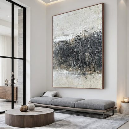 Abstract Black White Crackle Texture Art (AURA219) | Modern Abstract Minimalist Luxe Wall Decor. Thick knife strokes, tactile plaster finish, 3D impasto, subtle light gold/beige undertones. Displayed above a sleek white console table in a minimalist contemporary entryway, serving as a captivating focal point. Balances deep black, soft off-white & gray with intentional crackle texture (wabi-sabi influences). Framed abstract piece with strong light-dark contrast and layered, tactile surface—ideal for modern b