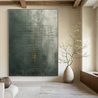 Modern abstract geometric wall art with dark green, charcoal gray base and metallic gold accent lines. Thick impasto brushstrokes and scratch marks create a 3D tactile texture. Displayed as a striking focal point in a sleek modern bedroom, complementing light gray bedding and natural wood nightstands. Slim black aluminum frame, ready to hang—ideal for living room, bedroom, or office decor.