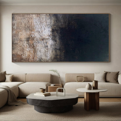 Abstract Blue Wall Art AURA182 - Modern Minimalist Tactile Plaster Textured Artwork with Wabi-sabi Influences. Deep indigo and charcoal hues transition to soft taupe/off-white gradient (dark top to light bottom), featuring 3D sculpted cracked, mottled impasto strokes for organic raw beauty. Hanging vertically above gray sofa in modern living room, ideal for Japandi decor, tall narrow spaces, minimalist bedrooms or contemporary offices to add serene depth.