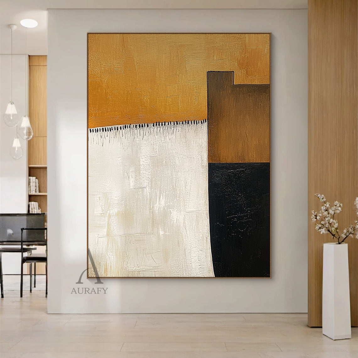 AURA641 Abstract Brown Beige Wall Art, modern organic abstract impasto painting with thick tactile brush strokes, presented hung in a sunlit contemporary neutral living room above a low cream boucle sofa. It features the signature large warm amber brown top block, vertical soft beige left block, dark brown and deep black geometric blocks on the right, with delicate black tassel-style short brush strokes as detailing between the brown and beige areas. All color blocks have clear visible hand-painted brush te