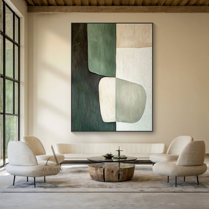 AURA405 modern organic abstract wall art, oil-acrylic blend with tactile brush stroke texture, features soft-edged muted dark green, sage green, warm beige and off-white color blocks with a two-tone irregular oval shape at lower center, displayed hung above a low-profile cream linen sofa in a sunlit wabi-sabi style living room, balanced earthy tone abstract artwork suitable for minimalist, quiet luxury, natural and Scandinavian home interior decor