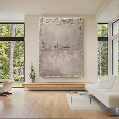 Wabi Sabi Abstract Tactile Impasto Gray Wall Art with Muted Pink Undertones & Distressed Surface (AURA191) - A warm focal point in a cozy bohemian bedroom. Features layered impasto texture, weathered patterns, soft silvery grays to deep charcoal, subtle pink hints. Displayed above a warm wooden bed frame with beige linen bedding, complementing woven macramé wall hangings, a potted fiddle leaf fig in the corner, and soft ambient light from a ceramic table lamp. Ideal for bohemian, organic home decor.