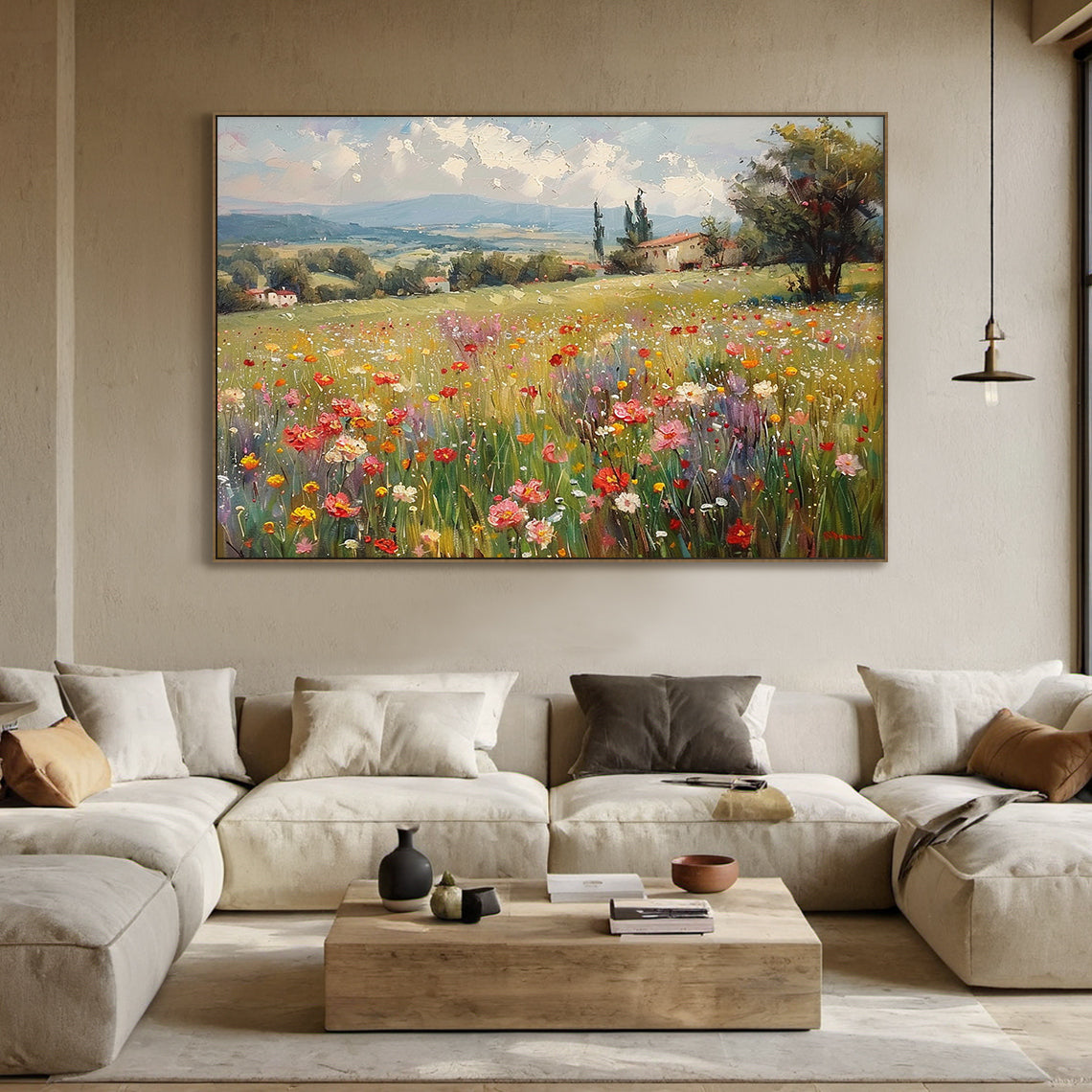 Impressionist impasto landscape canvas wall art, foreground is thickly painted wildflower meadow with green stems, bright yellow, red, pink, white, purple blooms with rich tactile texture. Middle ground features rolling green South European countryside slopes, scattered red-roofed rural farmhouses, cypress and broadleaf trees. Background has hazy blue-grey mountains, bright blue sky dotted with thick white clouds, sunlit pastoral artwork for modern organic home decor.