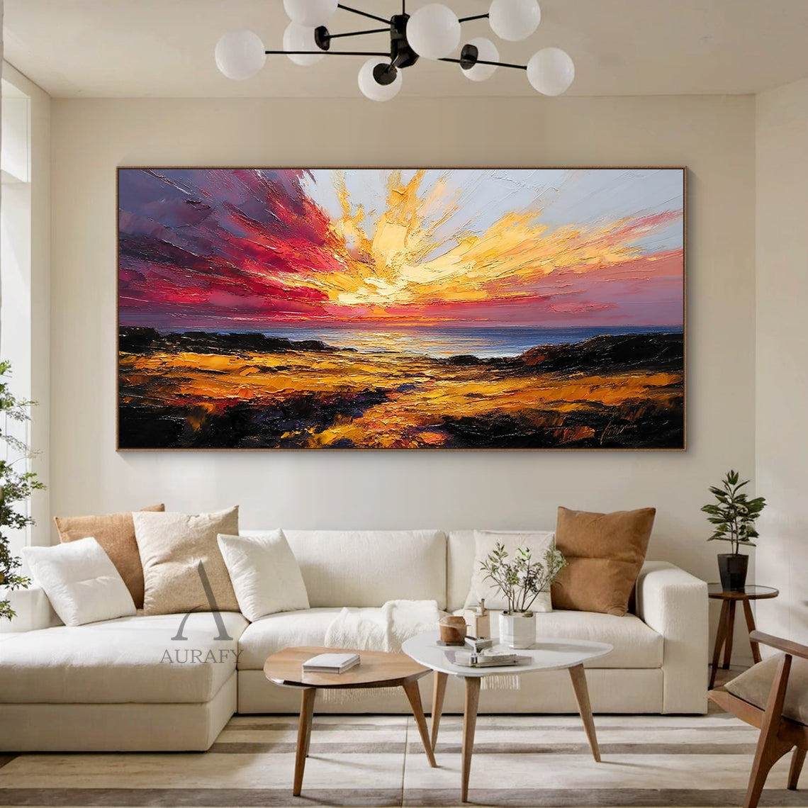 Textured palette knife impasto coastal sunset seascape painting, hung as the focal decor on the light gray accent wall of a contemporary minimalist living room above a cream linen sofa, its warm golden sun, burnt orange cloud and deep indigo sea tones harmonize beautifully with the neutral wood and soft fabric furnishings, the thick raised sculptural impasto brushstrokes are clearly visible even from a distance bringing rich tactile layering, this stunning warm-toned coastal nature wall art is a perfect pic