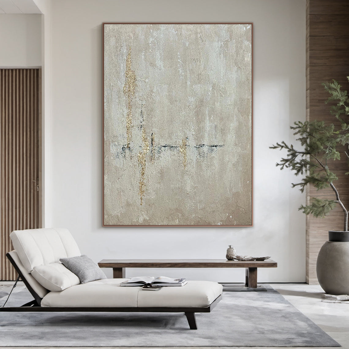 AURA226 Beige Wabi Sabi Abstract Wall Art with Gold Accents in Brown Frame - Textured muted beige base with organic hand-applied gold leaf strokes. Displayed in modern living room above wooden coffee table, complementing white lounge chair and neutral decor. Ideal focal point for living room, bedroom, or office minimalist/boho home decor. Captures wabi sabi’s imperfection and serene simplicity, adding understated luxury to modern spaces.