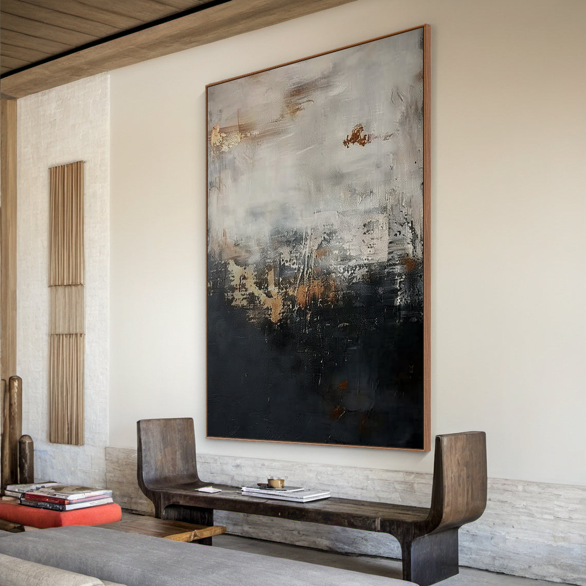 Wabi Sabi abstract sculpted canvas art with impasto knife strokes and tactile surface—deep black lower section, light gray upper layer, golden copper accents. Displayed in a cozy natural minimalist nook: warm oak desk, rattan armchair, potted fiddle-leaf fig, neutral linen curtains, soft natural light filtering through. Embraces Wabi Sabi’s imperfect beauty and subtle warm softness (Pink vibe) for calm, minimalist home decor. AURA196.