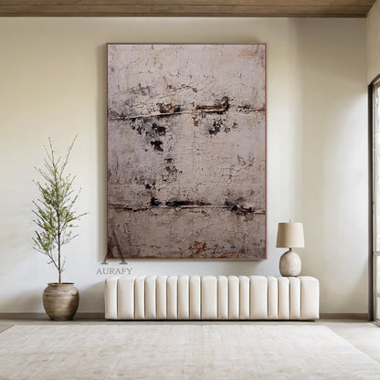 Large vertical abstract wall art with a textured, cracked surface in neutral beige, gray, and subtle brown/black tones, framed in a thin brown border. Displayed in a modern bedroom setting above a wooden nightstand, next to a white ceramic vase with green foliage and a small woven basket—ideal for minimalist or modern bedroom decor accents.