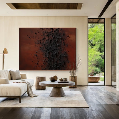 Wabi Sabi Handcrafted Textured Abstract Wall Art in Deep Red & Charcoal Black. High-Relief Plaster Surface with Organic Imperfections, Perfect for Serene Minimalist Bedrooms, Japandi Decor, or Cozy Home Nooks. Displayed Above Light Gray Bed Headboard in a Wabi Sabi Style Bedroom with Wooden Nightstands & Warm Glow Table Lamps. Ideal for Infusing Tactile Depth to Japandi Bedrooms or Minimalist Reading Corners, Embodying Wabi Sabi’s Celebration of Imperfect Beauty.