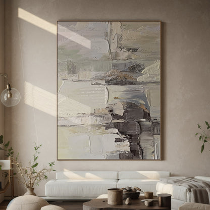 Wabi Sabi Abstract Textured Wall Art - Hand-applied impasto acrylic paint with thick, organic brushstrokes and palette knife texture. Neutral tones (beige, soft gray, off-white) with subtle pink accents, framed in natural wood. Displayed against a light gray bedroom wall, the raised texture interacts with warm lamplight—casting gentle shadows that highlight its tactile details, perfect for minimalist/bohemian/Scandinavian decor. Ideal for living room too, ready to hang with pre-installed kit.