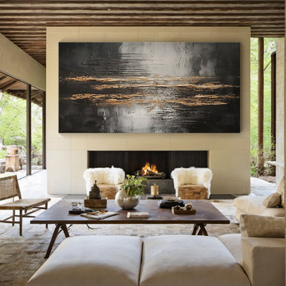 Wabi Sabi Abstract Impasto Wall Art with Thick Tactile Cracked Surface - Horizontal Canvas Above Beige Linen Sofa in Bright Japandi Living Room. Black Gray White Base with Flowing Gold Accents, Handcrafted Imperfect Texture for Minimalist or Organic Modern Decor. Aura190 Artwork Focal Point for Warm Neutral Living Space.