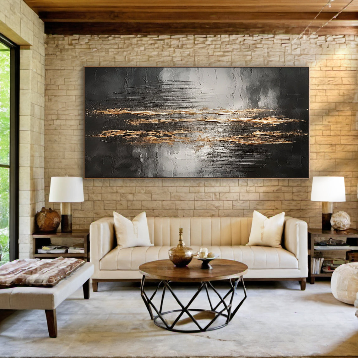 Wabi Sabi Abstract Impasto Wall Art with Thick Tactile Cracked Surface - Horizontal Canvas Above Beige Linen Sofa in Bright Japandi Living Room. Black Gray White Base with Flowing Gold Accents, Handcrafted Imperfect Texture for Minimalist or Organic Modern Decor. Aura190 Artwork Focal Point for Warm Neutral Living Space.