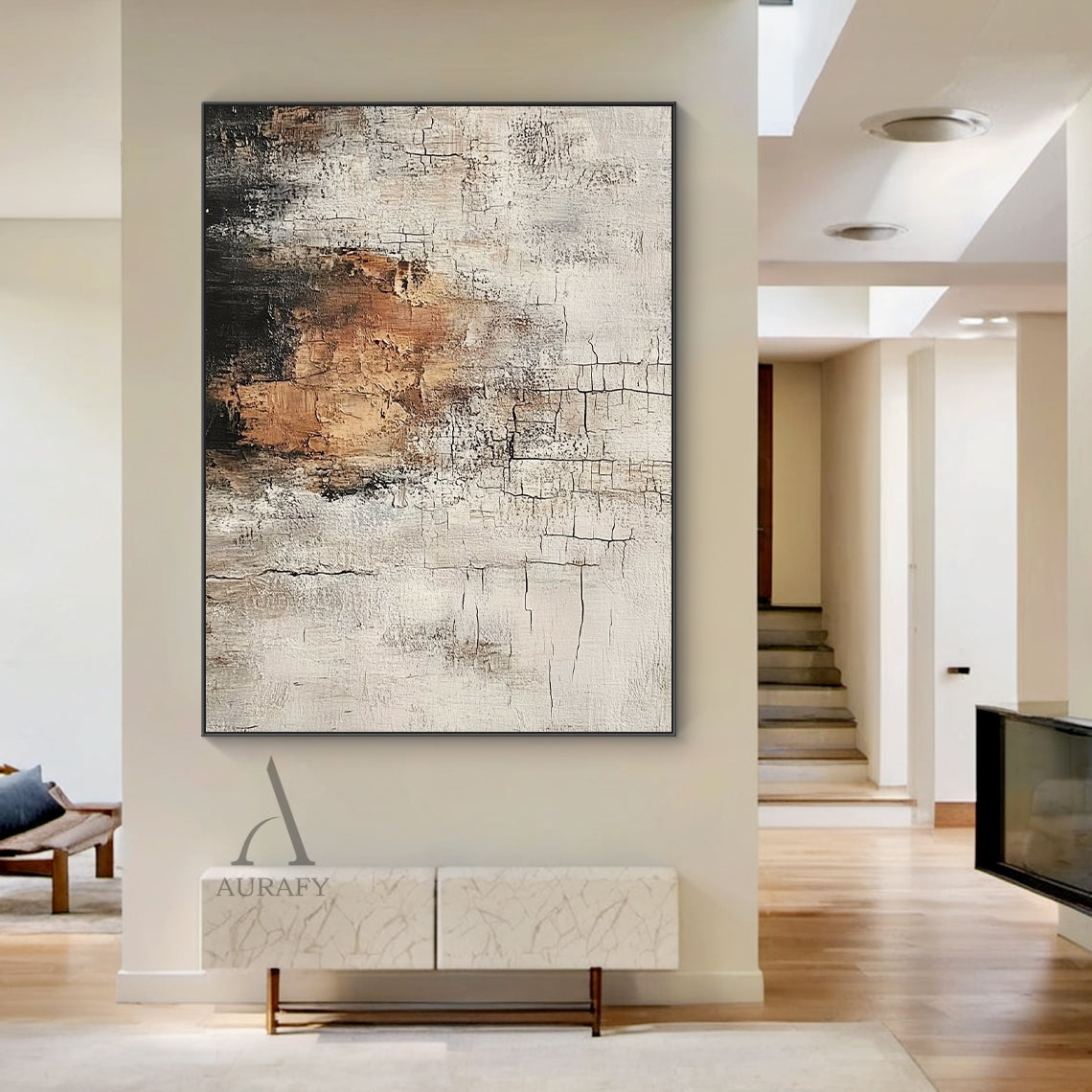 Scened Abstract textured Wabi-sabi wall art (AURA636), features hand-applied cracked plaster texture with thick rough paint finish, light beige as base tone, warm brown color block sits on middle left as visual focus, dark gray near black gradient at top left, non-figurative abstract composition, presents weathered aged vintage serene vibe, real shot displayed in a soft-toned modern minimalist bedroom matched with low-profile oak bed frame, creamy linen bedding and matte terracotta decor pieces, ideal for a