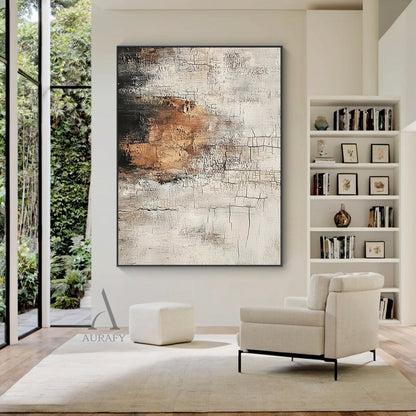Scened Abstract textured Wabi-sabi wall art (AURA636), features hand-applied cracked plaster texture with thick rough paint finish, light beige as base tone, warm brown color block sits on middle left as visual focus, dark gray near black gradient at top left, non-figurative abstract composition, presents weathered aged vintage serene vibe, real shot displayed in a light-toned Japandi minimalist living room matched with log furniture and linen soft furnishings, ideal for neutral organic home decoration in l
