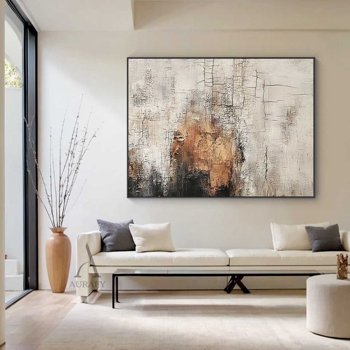 Scened Abstract textured Wabi-sabi wall art (AURA636), features hand-applied cracked plaster texture with thick rough paint finish, light beige as base tone, warm brown color block sits on middle left as visual focus, dark gray near black gradient at top left, non-figurative abstract composition, presents weathered aged vintage serene vibe, real shot displayed in a light-toned Japandi minimalist living room matched with log furniture and linen soft furnishings, ideal for neutral organic home decoration in l