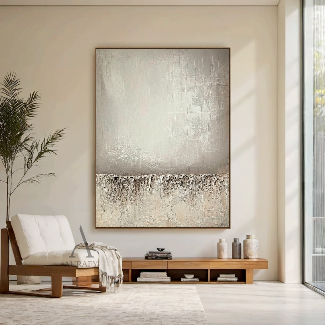 Beige wabi-sabi general abstract canvas wall art AURA724 with split composition. Lower section adopts thick rugged impasto texture like weathered rock and dry land with natural uneven edges. Upper left part has smooth brushed warm beige gradient with faint brush stroke textures, upper right part comes with subtle etched cross-hatch lines and mottled worn details. The whole work uses monochromatic neutral tones of beige, taupe and off-white, it is a minimalist Japandi luxe tactile artwork for neutral home de