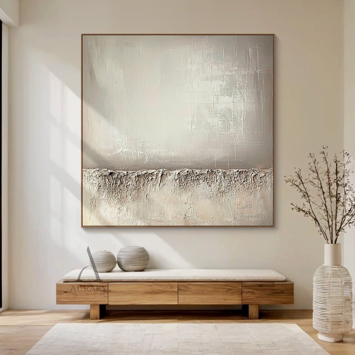 Beige wabi-sabi general abstract canvas wall art AURA724 with split composition. Lower section adopts thick rugged impasto texture like weathered rock and dry land with natural uneven edges. Upper left part has smooth brushed warm beige gradient with faint brush stroke textures, upper right part comes with subtle etched cross-hatch lines and mottled worn details. The whole work uses monochromatic neutral tones of beige, taupe and off-white, it is a minimalist Japandi luxe tactile artwork for neutral home de