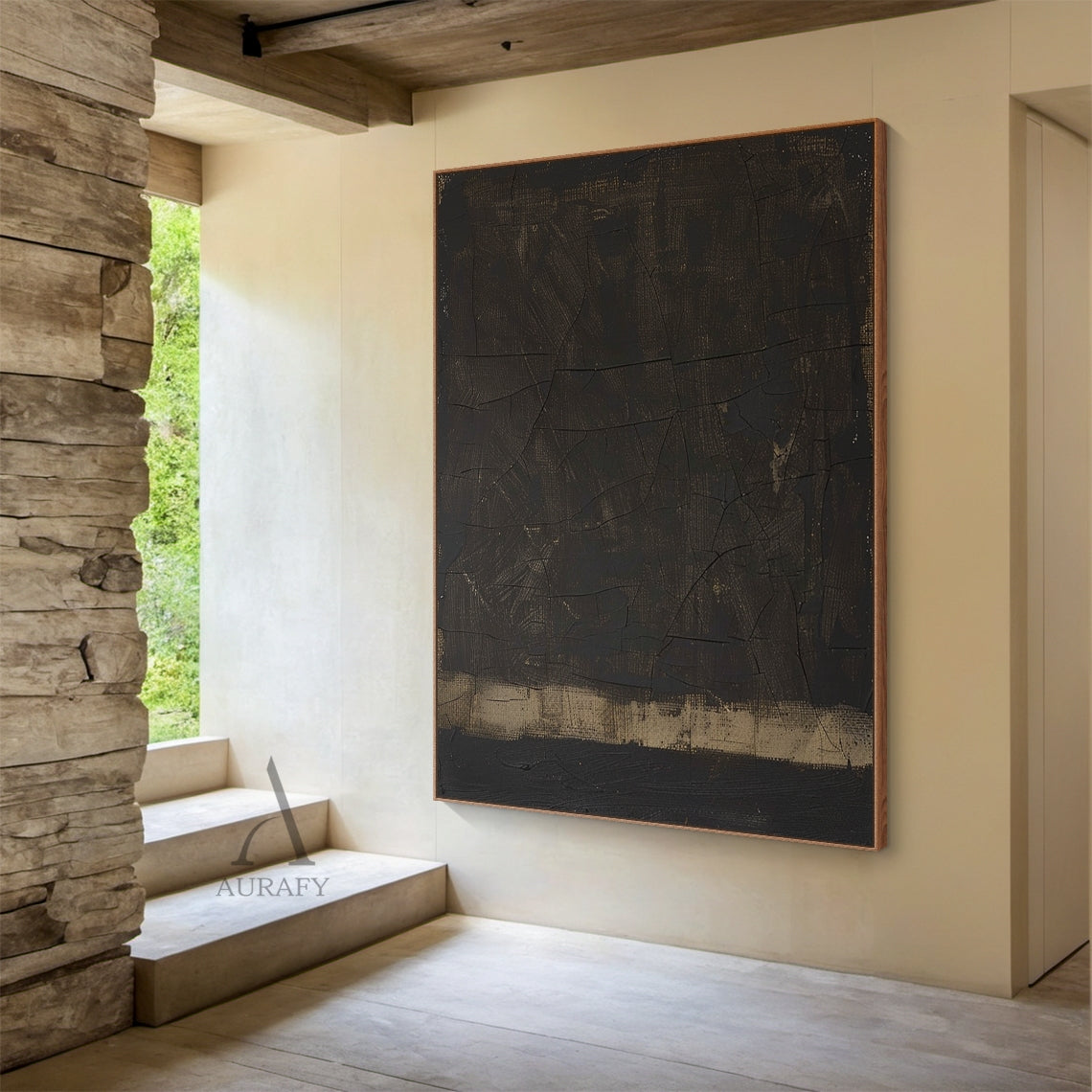 Wabi Sabi Black Abstract Cracked Textured Japandi Canvas Wall Art AURA796 (Lifestyle Display Edition): Minimalist luxe neutral decor artwork showcased in a curated cozy Japandi living space styling context, retaining its signature deep inky black heavy impasto main field, natural craquelure cracked texture across the full dark surface, subtle warm ochre and gilded undertones peeking through worn hand-applied brush strokes and paint gaps, a muted sand-toned horizontal anchor band at the base, raw woven canva