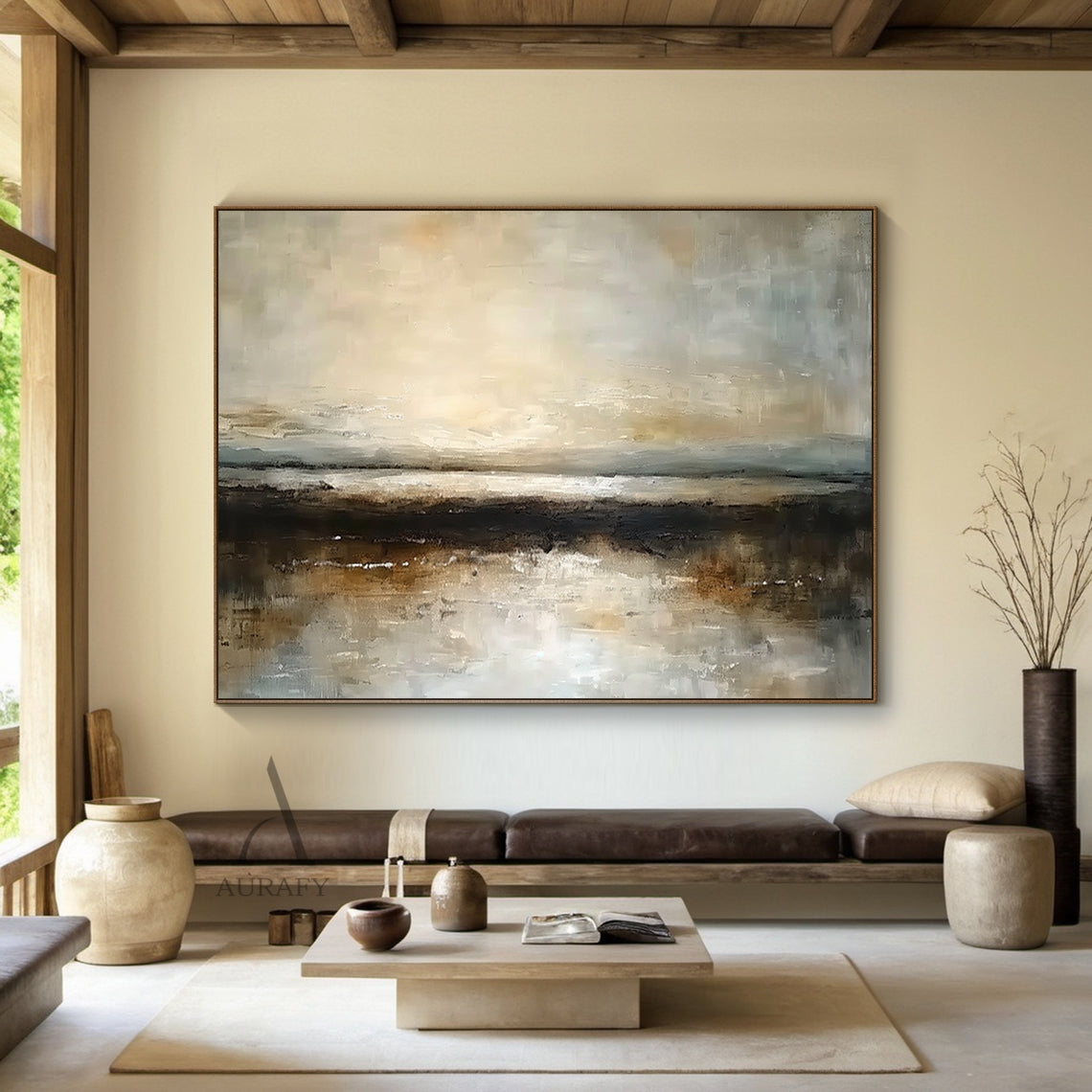 Wabi-Sabi brown abstract landscape impasto canvas artwork AURA742, textured abstract painting of hazy misty shoreline hung in minimalist Japandi interior display scene, upper section with soft blended warm beige, sun-kissed gold and pale gray blocks simulating dawn/dusk misty sky, middle textured gray layer with subtle light-reflecting strokes mimicking open water surface, lower deep brown and umber thick impasto blocks as dark shore bank, muted earthy color palette with subtle metallic flecks, complementin