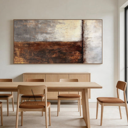 Wabi-sabi abstract wall art (AURA405) displayed above a soft gray linen headboard in a minimalist bedroom bathed in gentle natural light; split composition featuring warm brown and gold textured brushstrokes on the left, soft beige and gray tones on the right, matte finish, handcrafted uneven edges, and horizontal line accent—ideal for Japandi living rooms, minimalist bedrooms, bohemian entryways, or neutral-toned home office spaces.