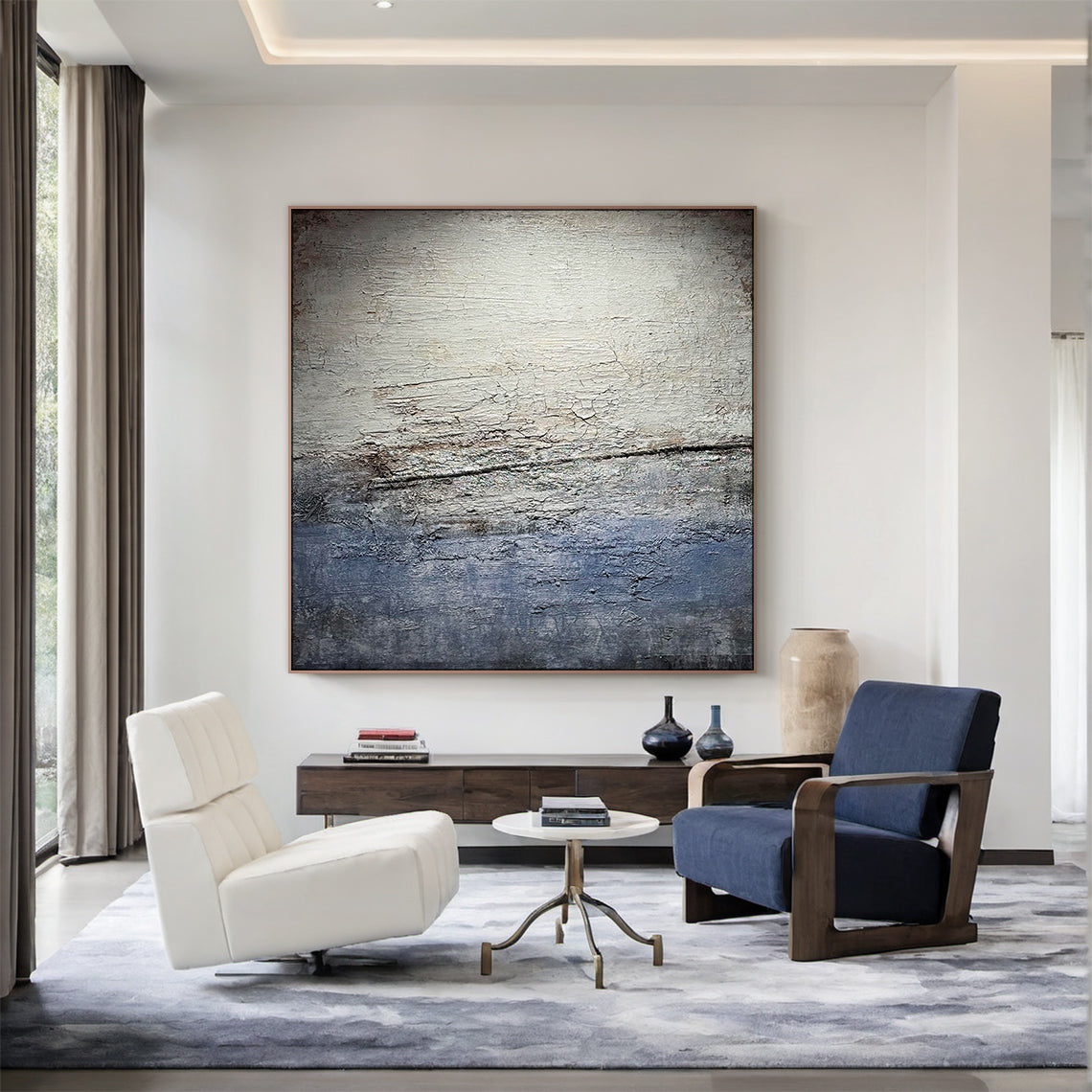 Wabi Sabi Gray Blue Abstract Textured Wall Art AURA225 - Vertical canvas with cracked layered finish in muted grays, soft blues & warm neutrals, styled as a focal point in a sunlit home office. Ideal home office statement piece, dining room wall accent or hallway decor. Complements minimalist, contemporary or Scandi decor styles. Adds depth & serenity to modern interiors, merging organic imperfection with modern elegance for timeless charm.