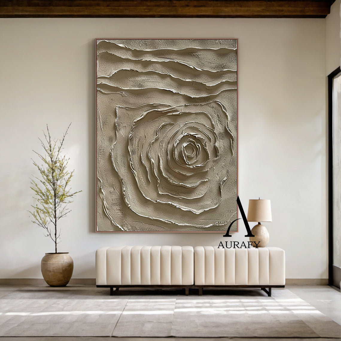 Real home installation scene display of handcrafted 3D textured plaster painting in muted warm brown earth tone, features raised impasto spiral abstract rose motif at lower half and horizontal wavy layered textured bands on upper section, matte tactile high-relief wabi-sabi japandi minimalist wall art, AURA538 by Aurafy