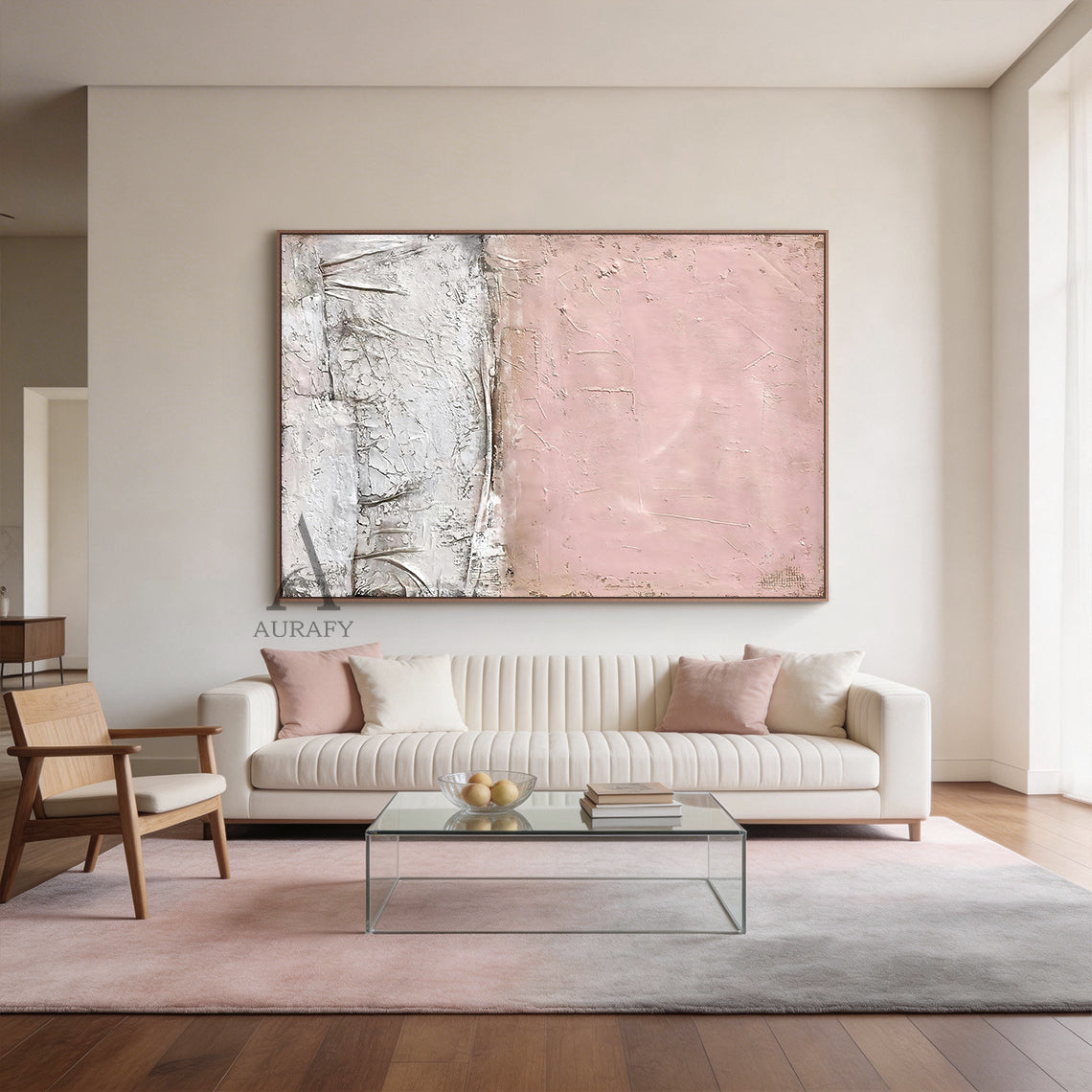 WABI SABI Pink Abstract Textured Wall Art (AURA245) - Soft Blush Upper Half with Visible Brush Strokes & Imperfections, Lower Half in White & Neutral Cracked Layered Finish. Framed in Thin Light Wood Frame. Displayed in Modern Minimalist Living Room: Light Gray Linen Sofa, Natural Wood Coffee Table with White Ceramic Vase Holding Dried Twigs, Warm Glow Floor Lamp, Beige Wool Rug, Small Rattan Side Table with Potted Eucalyptus. Perfect for Minimalist Home Decor, Wabi Sabi Inspired Living Space Accent, Cozy L
