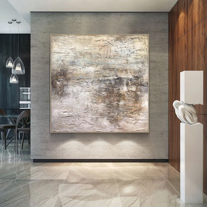 Wabi Sabi Abstract Art AURA217 - Hand-painted high-relief plaster wall decor with soft muted pink and warm neutral tones (beige, taupe, light gray). Hung on a warm beige wall above a low wooden coffee table in a cozy Japandi living room, showcasing its tactile uneven texture with thick brushstrokes and intentional imperfections. Ideal for Japandi living rooms, entryways, or modern organic spaces, complements neutral walls, wood accents, and soft linen furniture.