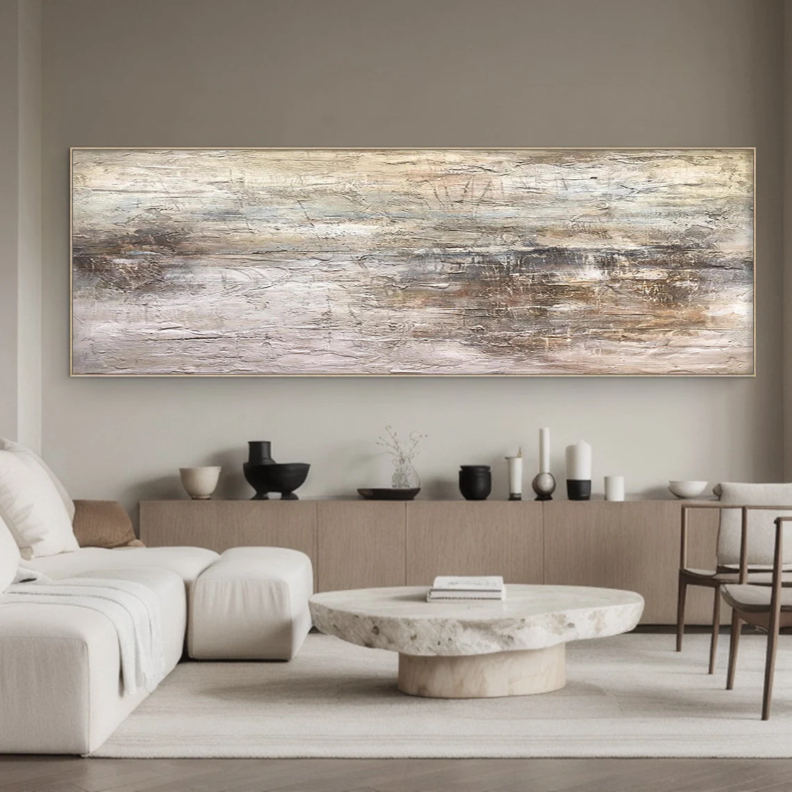Wabi Sabi Abstract Art AURA217 - Hand-painted high-relief plaster wall decor with soft muted pink and warm neutral tones (beige, taupe, light gray). Hung on a warm beige wall above a low wooden coffee table in a cozy Japandi living room, showcasing its tactile uneven texture with thick brushstrokes and intentional imperfections. Ideal for Japandi living rooms, entryways, or modern organic spaces, complements neutral walls, wood accents, and soft linen furniture.